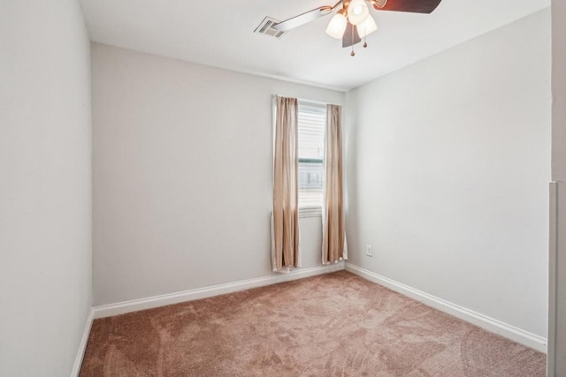 unfurnished room with baseboards, carpet, a ceiling fan, and visible vents