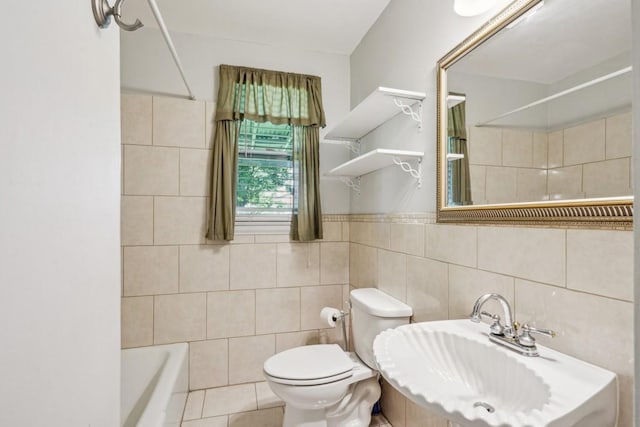 full bath featuring toilet, tile walls, and a sink