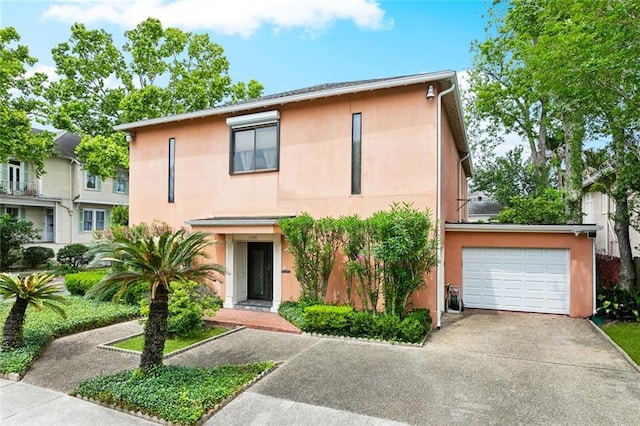 2100 Jefferson Ave, New Orleans, LA 70115 - multi unit property featuring driveway, stucco siding, and a garage