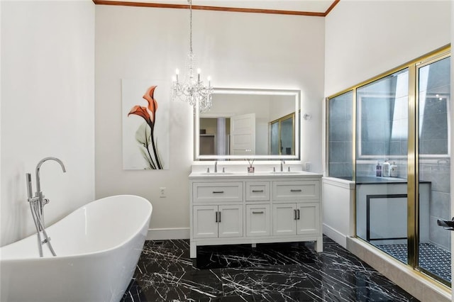 2100 Jefferson Ave, New Orleans, LA 70115 - bathroom with marble finish flooring, baseboards, double vanity, a freestanding tub, and a chandelier