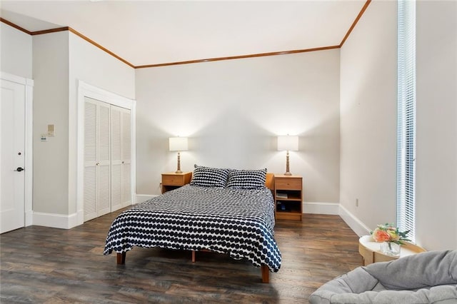 2100 Jefferson Ave, New Orleans, LA 70115 - bedroom with crown molding, baseboards, wood finished floors, and a closet