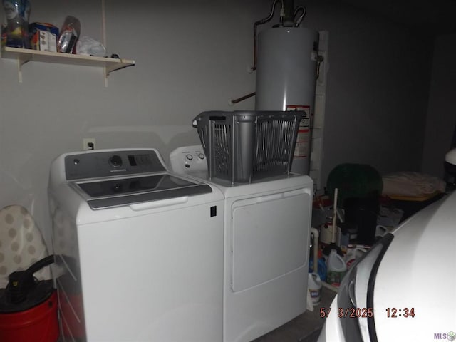 laundry area featuring gas water heater, laundry area, and washer and clothes dryer