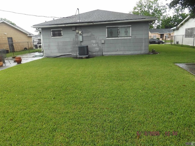 back of property with a shingled roof