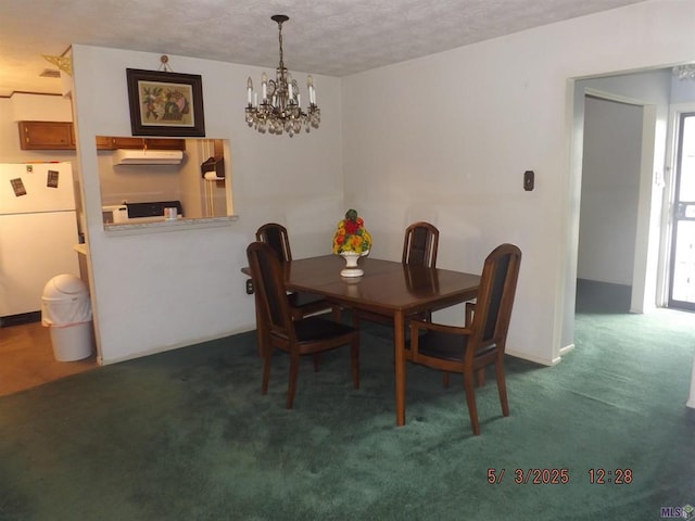 dining room with carpet and a chandelier