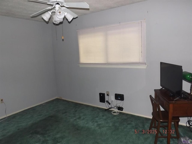carpeted office featuring ceiling fan and baseboards