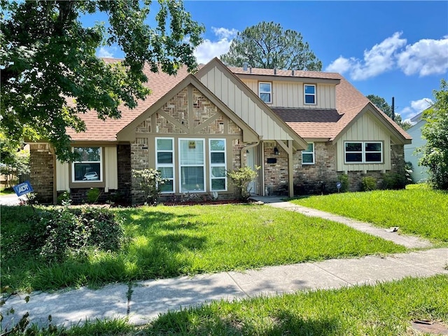 2644 Ramsey Dr, New Orleans, LA 70131 - view of front of property with a shingled roof, board and batten siding, stone siding, and a front yard