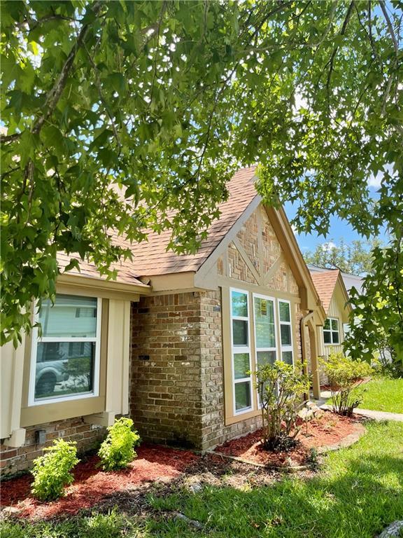 2644 Ramsey Dr, New Orleans, LA 70131 - view of side of property featuring brick siding and a shingled roof