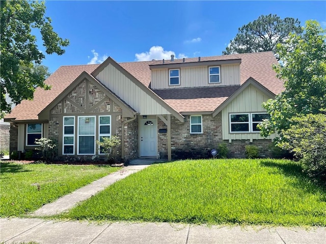 2644 Ramsey Dr, New Orleans, LA 70131 - view of front of home with a shingled roof, board and batten siding, stone siding, and a front yard