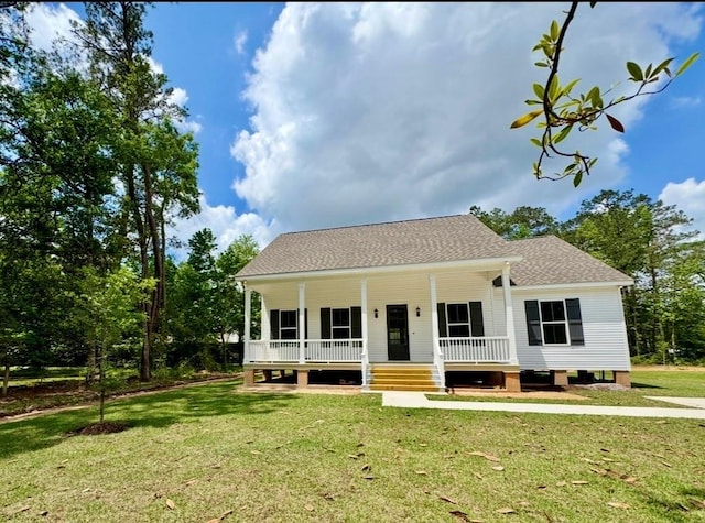 bungalow-style house with roof with shingles, a porch, and a front yard