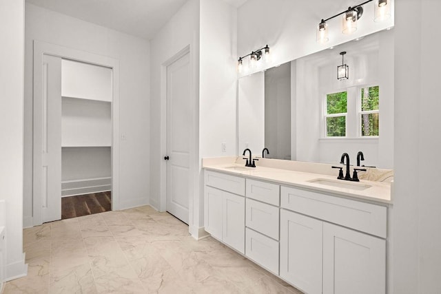 71131 Sanders St, Abita Springs, LA 70420 - full bathroom featuring double vanity, marble finish floors, and baseboards