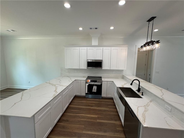 kitchen with a sink, appliances with stainless steel finishes, a peninsula, and visible vents