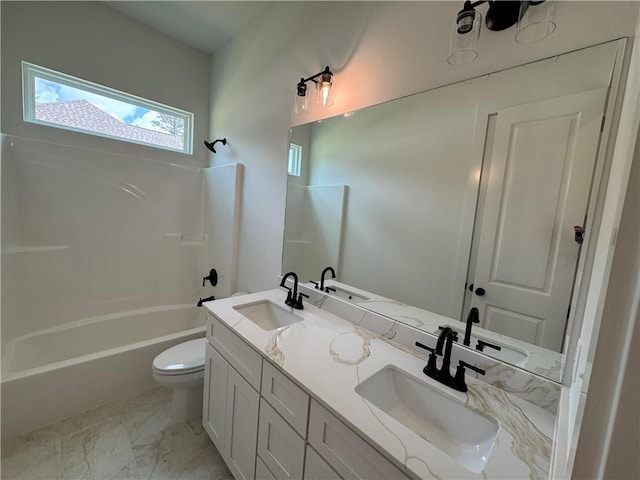 bathroom with a sink, toilet, double vanity, and shower / tub combination