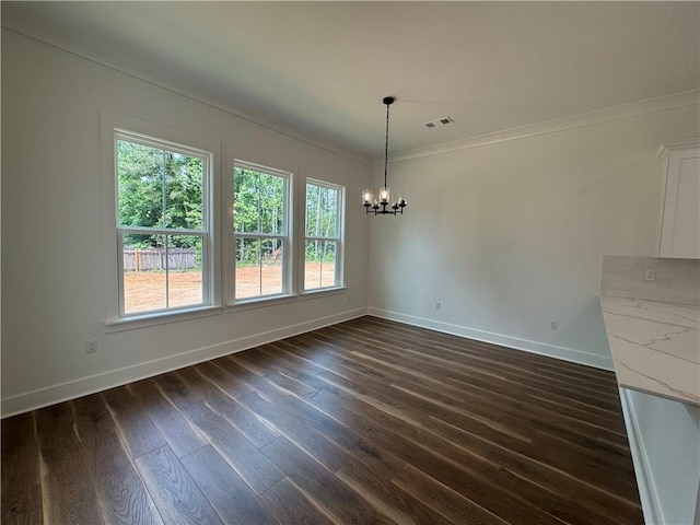 unfurnished dining area featuring baseboards, a notable chandelier, plenty of natural light, and ornamental molding