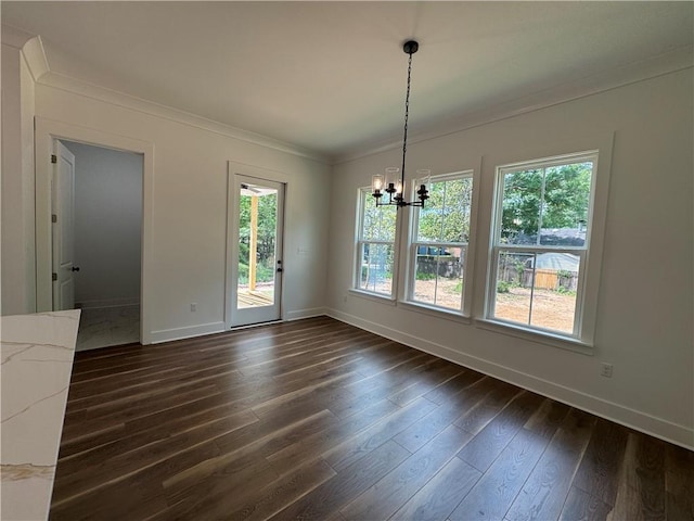 unfurnished dining area with crown molding, baseboards, an inviting chandelier, and a healthy amount of sunlight