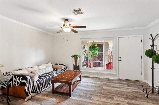 7020 Wilty St, Metairie, LA 70003 - living room with wood finished floors, a ceiling fan, and crown molding