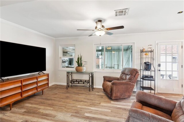 7020 Wilty St, Metairie, LA 70003 - living room featuring plenty of natural light, ceiling fan, wood finished floors, and ornamental molding