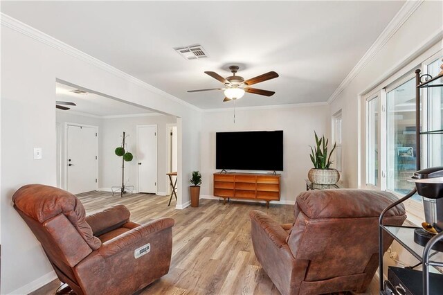 7020 Wilty St, Metairie, LA 70003 - living room featuring ceiling fan, light wood-style floors, and ornamental molding