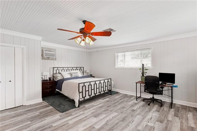 7020 Wilty St, Metairie, LA 70003 - bedroom with ornamental molding, an AC wall unit, light wood finished floors, an office area, and a ceiling fan