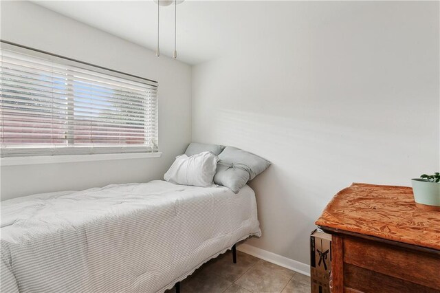 7020 Wilty St, Metairie, LA 70003 - bedroom with tile patterned flooring and baseboards