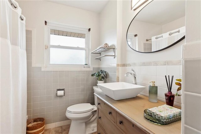 7020 Wilty St, Metairie, LA 70003 - full bath with tile walls, vanity, tile patterned flooring, wainscoting, and a shower with shower curtain