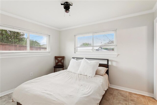 7020 Wilty St, Metairie, LA 70003 - bedroom featuring multiple windows, crown molding, and light tile patterned floors