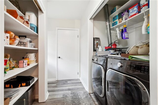 7020 Wilty St, Metairie, LA 70003 - laundry area featuring wood finished floors and washing machine and clothes dryer