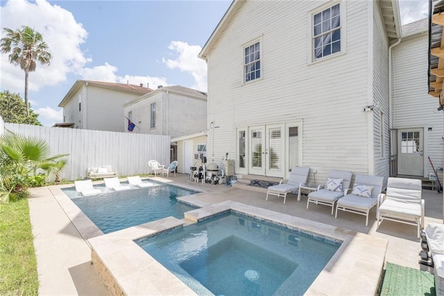 3408 Nashville Ave, New Orleans, LA 70125 - view of swimming pool featuring a patio area, fence, french doors, and a pool with connected hot tub