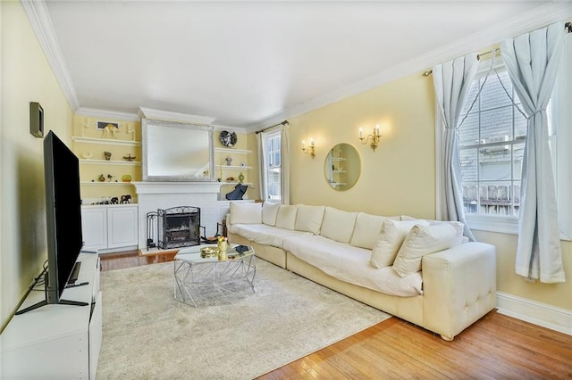 3408 Nashville Ave, New Orleans, LA 70125 - living area featuring crown molding, baseboards, a brick fireplace, and wood finished floors