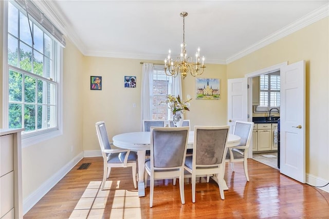 3408 Nashville Ave, New Orleans, LA 70125 - dining space featuring visible vents, light wood finished floors, a notable chandelier, and a healthy amount of sunlight