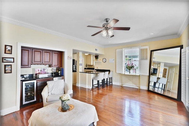 3408 Nashville Ave, New Orleans, LA 70125 - living area featuring ceiling fan, wood finished floors, a bar, wine cooler, and ornamental molding