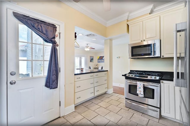 3408 Nashville Ave, New Orleans, LA 70125 - kitchen featuring ceiling fan, crown molding, dark countertops, baseboards, and stainless steel appliances