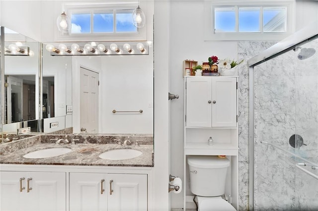 3408 Nashville Ave, New Orleans, LA 70125 - bathroom with double vanity, a sink, a shower with door, and toilet