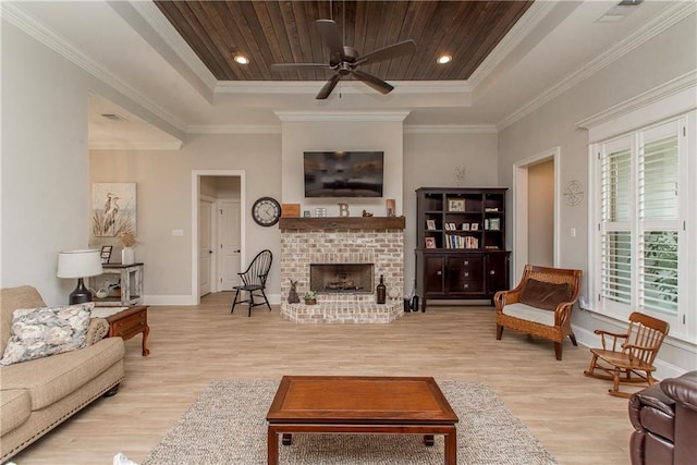 living room featuring crown molding, a tray ceiling, and wood finished floors
