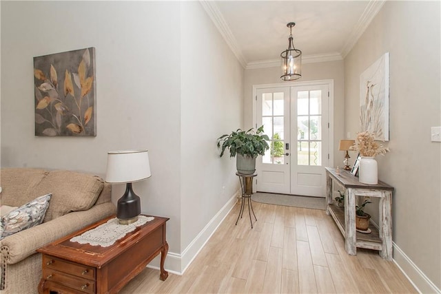 doorway to outside featuring crown molding, baseboards, french doors, and light wood-type flooring