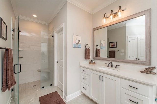 bathroom with crown molding, baseboards, a stall shower, and vanity