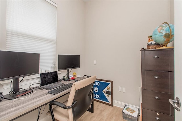 office space featuring baseboards and light wood-type flooring