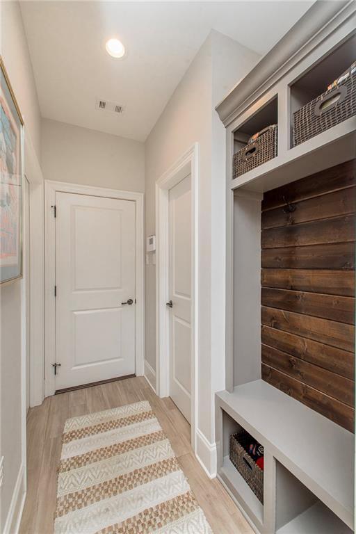 mudroom featuring recessed lighting, baseboards, light wood finished floors, and visible vents