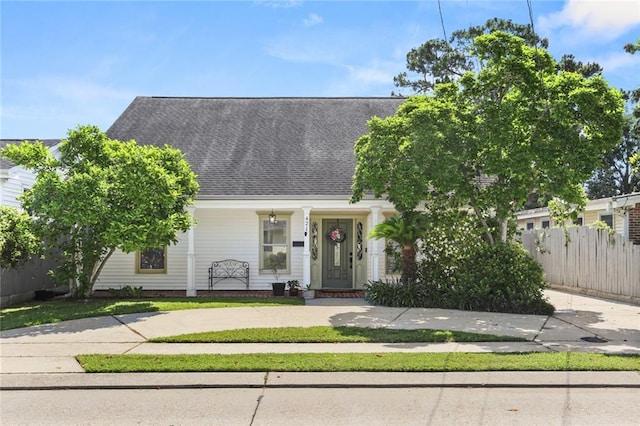 421 Oaklawn Dr, Metairie, LA 70005 - view of front of property with covered porch, roof with shingles, fence, and a front yard