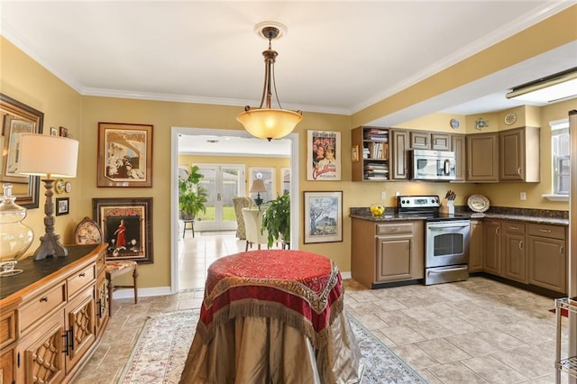 421 Oaklawn Dr, Metairie, LA 70005 - kitchen featuring a wealth of natural light, baseboards, dark countertops, and appliances with stainless steel finishes