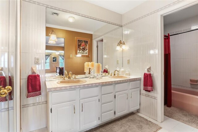 421 Oaklawn Dr, Metairie, LA 70005 - bathroom featuring tile patterned floors, double vanity, shower / tub combo with curtain, and a sink