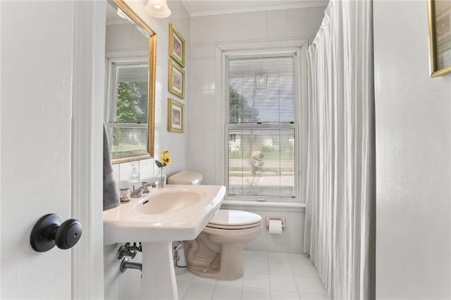 421 Oaklawn Dr, Metairie, LA 70005 - bathroom with toilet, a wealth of natural light, tile patterned flooring, and ornamental molding