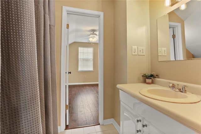 421 Oaklawn Dr, Metairie, LA 70005 - full bath featuring tile patterned flooring, baseboards, ceiling fan, vaulted ceiling, and vanity