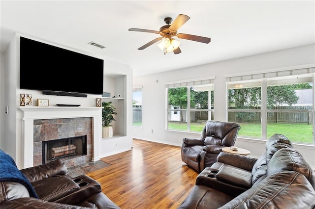 233 Arian Ln, Covington, LA 70433 - living room with ceiling fan, wood finished floors, and a tile fireplace