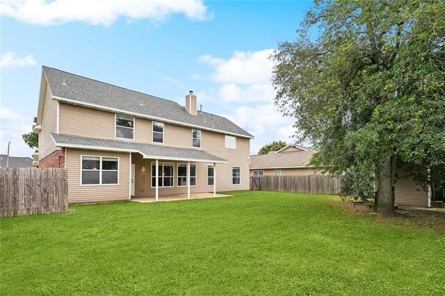 233 Arian Ln, Covington, LA 70433 - back of property with a fenced backyard, a patio, and a chimney
