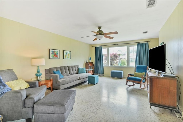 living room featuring a ceiling fan and visible vents