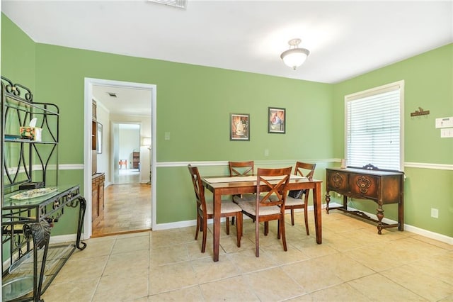 dining room with baseboards and light tile patterned floors