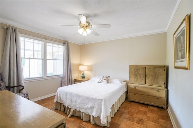 bedroom with crown molding, baseboards, and a ceiling fan