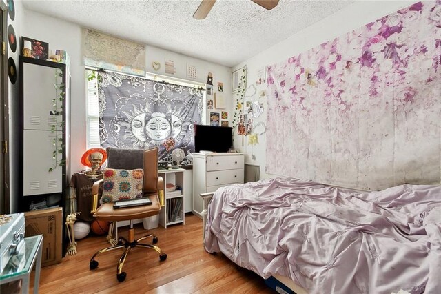 3118 Albany St, Kenner, LA 70065 - bedroom with a textured ceiling, wood finished floors, and ceiling fan