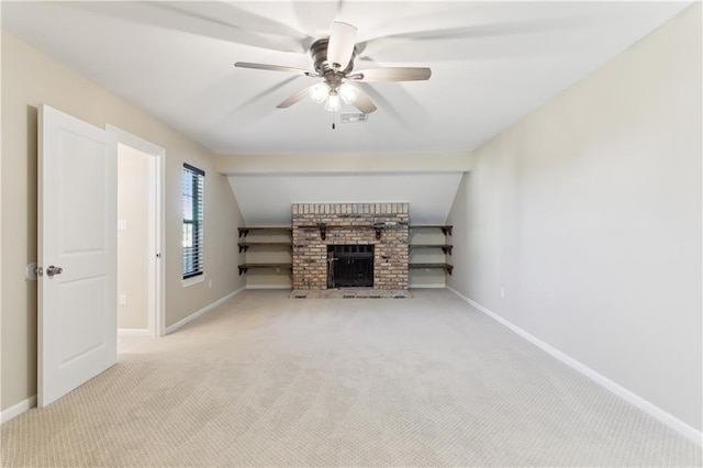 unfurnished living room with baseboards, ceiling fan, a brick fireplace, and light colored carpet