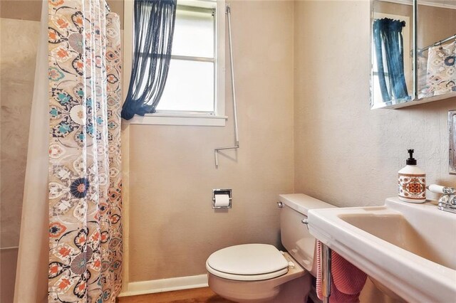 713 Lydia Ct, Marrero, LA 70072 - full bathroom with toilet, curtained shower, and a sink